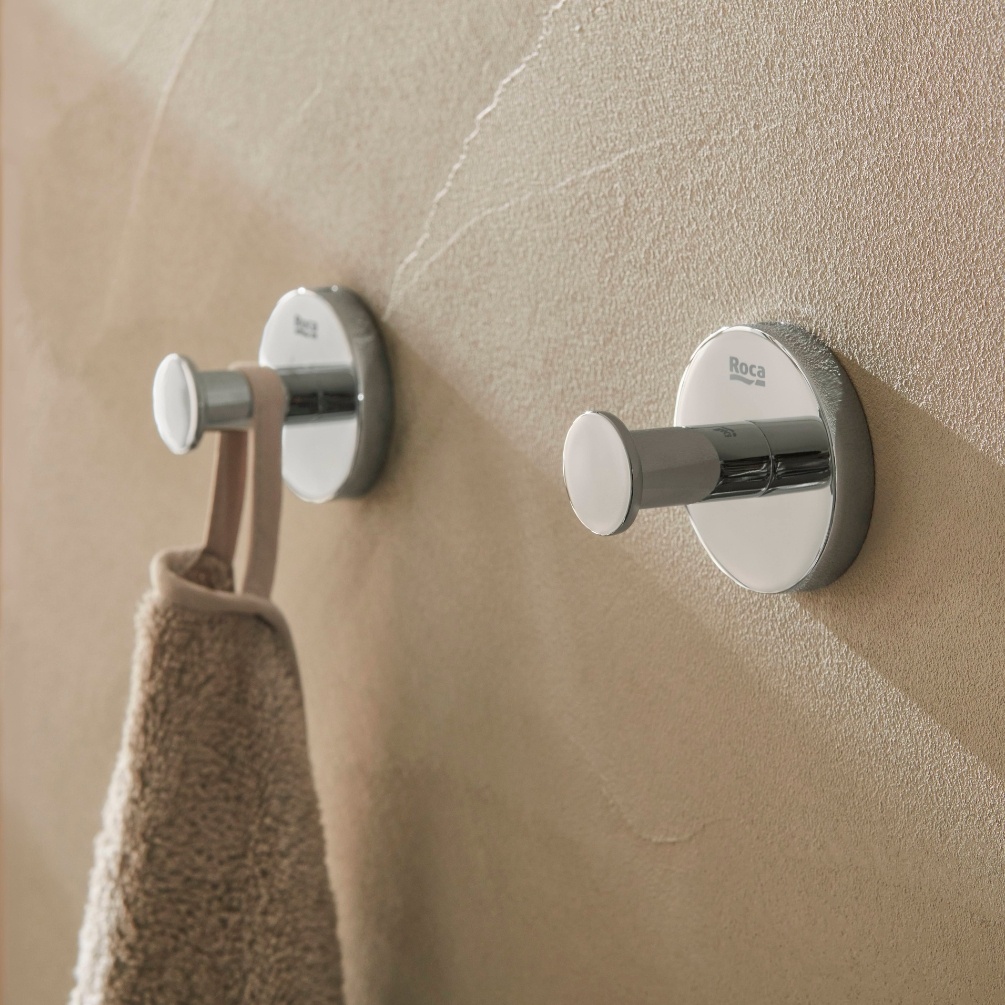 Lifestyle image of two Roca Hotels Chrome Robe Hooks with one holding a robe